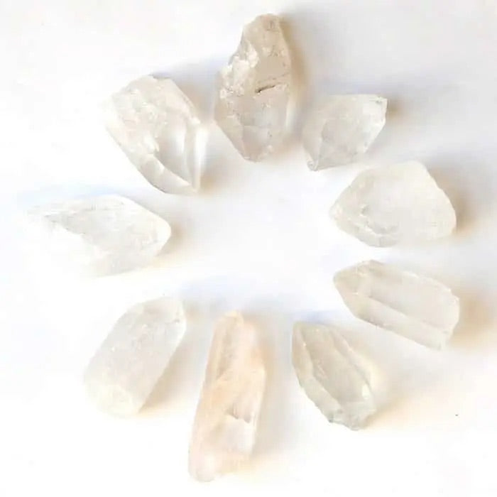 Clear Quartz Crystal Points in a a circle on whitebackground. 